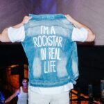 harrison rocke custom jean jacket i am a rock star in real life at swimweek 2024 dallas texas